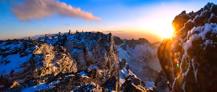 Sunrise breaking through snow-capped peaks of Mount Paektu